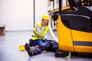 worker helping her injured co-worker on their workplace